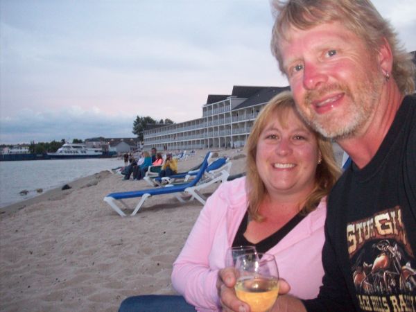 Glass of wine on the beach at sunset